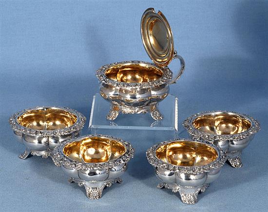 A set of four George III provincial silver table salts with matching mustard, Diameter 3 ¾”/94mm combined weight 21.5oz/609grm